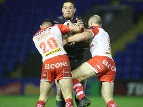 Toronto Wolfpack’s Sonny Bill gets tackled by two St. Helens players yesterday. Steve Gaunt photo