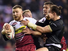 Jackson Hastings of Wigan is tackled by Andrew Dixon of the Toronto Wolfpack during a Betfred Super League match at DW Stadium on Feb. 13, 2020 in Wigan, England. (GARETH COPLEY/Getty Images)
