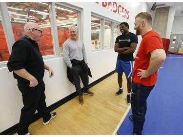 Clayton Pye (R), a wrestler at Brock University, speaks with his teammate Iggy Pitt , Brock wrestling coach Marty Calder  (grey top) and Steve Buffery. Pye has overcome adversity after almost being fatally stabbed a few years ago, is well on his way to competing for Canada at the Olympics.  in Toronto, Ont. on Tuesday February 18, 2020. Jack Boland/Toronto Sun/Postmedia Network