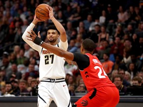 Denver Nuggets' Jamal Murray is guarded by Raptors'  Norman Powell during Sunday's game. (GETTY IMAGES)