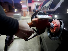 Filling up at the gas pumps  along Kingston Rd,in Toronto.