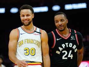 Golden State Warriors guard Stephen Curry and Toronto Raptors guard Norman Powell share a laugh during Thursday's game. (USA TODAY SPORTS)