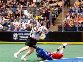 Calgary Roughnecks' Curtis Dickson takes a shot over a fallen Toronto Rock defender during Sunday's game at Scotiabank Arena. (PATRICK MCCULLOUGH PHOTO)