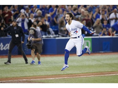Bo Bichette #11 of the Toronto Blue Jays leaps as he runs into home plate, after hitting a home run to score the winning run in the twelfth inning of their MLB game against the New York Yankees at Rogers Centre on September 13, 2019 in Toronto, Canada.