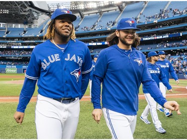 Vladimir Guerrero Jr. #27 and Bo Bichette #11 of the Toronto Blue Jays walk off the field after defeating the Tampa Bay Rays in the last game of the season in their MLB game at the Rogers Centre on September 29, 2019 in Toronto, Canada.