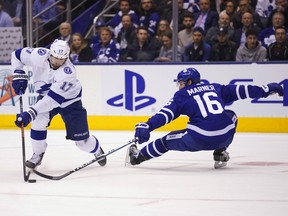 Tampa Bay Lightning forward Alex Killorn skates around Leafs winger Mitch Marner during Tuesday night’s game at Scotiabank Arena. (USA TODAY SPORTS)
