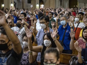 Filipinos wearing facemasks attend evening mass at a church on March 11, 2020 in Paranaque, Metro Manila, Philippines. The number of confirmed cases of COVID-19 in the Philippines rose to 49 after 16 new cases were announced on Wednesday. (Photo by Ezra Acayan/Getty Images)