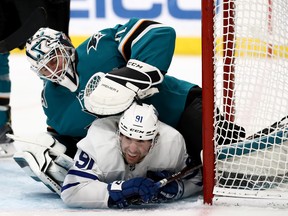 John Tavares of the Toronto Maple Leafs collides with goalie  Martin Jones of the San Jose Sharks at SAP Center on March 03, 2020 in San Jose, California. (Photo by Ezra Shaw/Getty Images)
