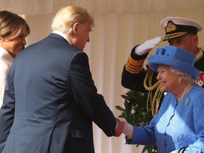 First Lady Melania Trump stands by as President Donald Trump shakes hands with Queen Elizabeth during the U.S. presidents trip to the U.K. on July 13, 2018. (AFP via Getty Images)