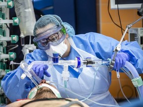 Medical workers wearing protective gear on March 28, 2020, treat a patient infected with the COVID-19 novel coronavirus at the intensive care unit of a hospital in Prague, Czech Republic. (Getty Images)