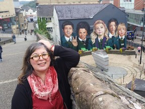 Rita DeMontis poses with the Derry Girls along the walled city of Derry.