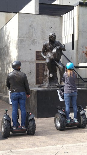 Tourists on Segways snap some photos of the Willie Nelson statue in downtown Austin. DAVE POLLARD/TORONTO SUN