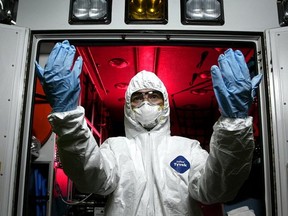 A woman in a protective Tyvek suit. (Toronto Sun files)