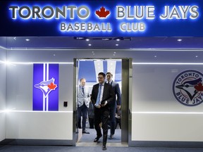 Toronto Blue Jays newly signed pitcher Hyun-Jin Ryu trails General Manager Ross Atkins as they arrive to a press conference announcing Ryu's signing to the team, in Toronto, Friday, Dec. 27, 2019. THE CANADIAN PRESS/ Cole Burston