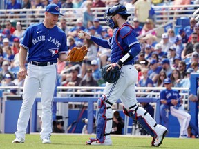Blue Jays catcher Danny Jansen walks out to the mound to give starting pitcher Chase Anderson a new baseball during the second inning yesterday against the Pittsburgh Pirates at TD Ballpark. Anderson wasn’t the only hurler hurt by wind-blown homers in a 19-13 Jays defeat. John David Mercer/USA TODAY