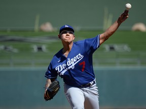 Los Angeles Dodgers starter Julio Urias pitches against the Texas Rangers during the first inning of a spring training game at Surprise Stadium. Joe Camporeale-USA TODAY Sports