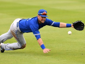 Blue Jays infielder Joe Panik, diving to knock down a grounder during a recent pre-season game,  has been an asset already, both at the plate and in the room, talking to the younger players about what it takes to play for a championship team.     
 Jonathan Dyer/USA TODAY Sports