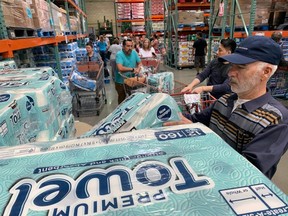 Customers line up to buy toilet paper, on fears that the coronavirus, COVID-19, will spread and force people to stay indoors,  at a Costco in Burbank, California on March 6, 2020.