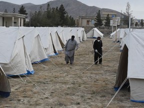 Workers of the Provincial Disaster Management Authority (PDMA) of Balochistan spray disinfectant on tents at a quarantine camp, prepared for people returning from Iran via the Pakistan-Iran border town of Taftan to prevent the spread the COVID-19 coronavirus, on the outskirts of Quetta on March 9, 2020.