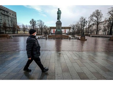 A man wearing a face mask, amid concerns of the COVID-19 coronavirus, walks on the empty Pushkinskaya square in downtown Moscow on March 20, 2020.
