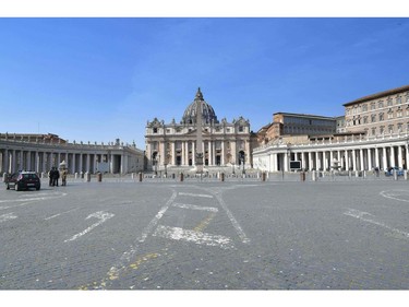 Italian Carabinieri officers stand in the empty Saint Peter's square on March 22, 2020 at the Vatican as the Mediterranean nation of 60 million overtook China as the global epicentre of COVID-19, the disease caused by the novel coronavirus.