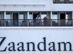 Passengers are seen onboard Holland America's cruise ship Zaandam as it entered the Panama City