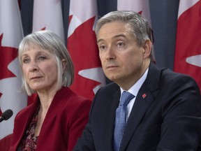 Minister of Foreign Affairs Francois-Philippe Champagne and Minister of Health Patty Hajdu listen to a question from the media during a news conference in Ottawa, Monday March 9, 2020. (THE CANADIAN PRESS/Adrian Wyld)