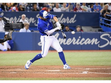 Toronto Blue Jays center fielder Randal Grichuk (15) hits a three run home run against the New York Yankees during the fifth inning at Rogers Centre.