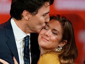 Prime Minister Justin Trudeau and his wife Sophie Gregoire Trudeau hug on stage after the federal election at the Palais des Congres in Montrea October 22, 2019. REUTERS/Carlo Allegri