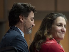 Prime Minister Justin Trudeau sits beside Deputy Prime Minister and Minister of Intergovernmental Affairs Chrystia Freeland before speaking to members of caucus on Parliament Hill in Ottawa, Thursday, Jan. 23, 2020.