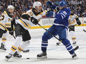 Zdeno Chara (left) of the Boston Bruins shoves Toronto Maple Leafs captain John Tavares during the playoffs last season. (Claus Andersen/Getty Images)