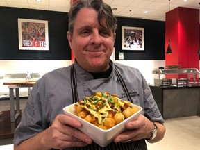 Maple Leaf Sports and Entertainment culinary director Chef Chris Zielinski holds up a bowl of chili cheese tots, one of eight new menu items at BMO Field for the 2020 season. JENNY YUEN/Toronto Sun