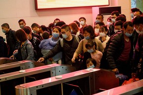 Passengers wearing face masks queue as they wait for the train to arrive at Jiujiang railway station in Jiujiang, a city which sits on the border between Chinas central Jiangxi province and Hubei province, the epicentre of the country’s COVID-19 coronavirus outbreak, on March 21, 2020. (Noel Celis/AFP via Getty Images)