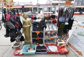 It was business as usual at curbside stores and fresh produce markets along Spadina Ave. in Chinatown on Thursday, March 26, 2020. (Jack Boland/Toronto Sun/Postmedia Network)