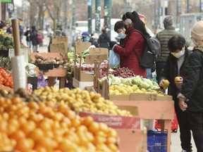 It was business as usual at curbside stores and fresh produce markets along Spadina Ave. in Chinatown on Thursday, March 26, 2020. (Jack Boland/Toronto Sun/Postmedia Network)
