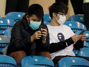 Fans wear face masks before the FA Cup Fifth Round match between Sheffield Wednesday and Manchester City amid concern following the coronavirus outbreak, on Wednesday, March 4, 2020.