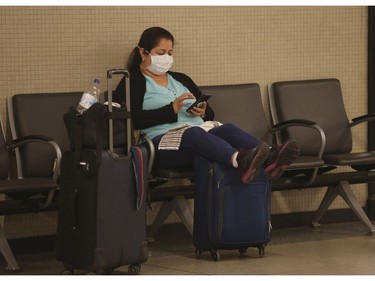 A passenger waits to board a Via Rail train  at Union Station. New domestic travel restrictions will be put in place Monday by the federal government - towards flight and rail travel  on Saturday March 28, 2020. Jack Boland/Toronto Sun/Postmedia Network