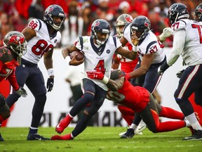 Texans quarterback Deshaun Watson (4) is sacked by Buccaneers defender Jason Pierre-Paul (90) during second half NFL action at Raymond James Stadium in Tampa, Fla., on Dec. 21, 2019.