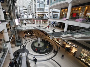 As new rules and guidelines were introduced to combat the spread of COVID-19, inside the Eaton Centre there were barely any shoppers and most stores were closed on Tuesday, March 17, 2020. (Jack Boland/Toronto Sun/Postmedia Network)