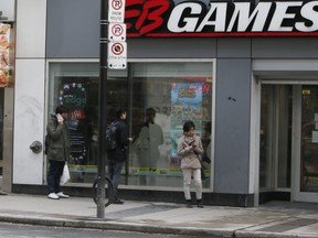 Despite the ongoing COVID-19 pandemic, people line up for the release of a new video game at EB Games on Yonge St. on Friday March 20, 2020. (Veronica Henri/Toronto Sun/Postmedia Network)