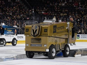 Chris Cotsilis (R) operates an ice resurfacer before a game between the Calgary Flames and the Vegas Golden Knights at T-Mobile Arena on October 12, 2019 in Las Vegas, Nevada.  (Photo by Ethan Miller/Getty Images)