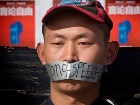 Chinese students hold a memorial for Dr Li Wenliang, who was the whistleblower of the Coronavirus, Covid-19, that originated in Wuhan, China and caused the doctors death in that city, outside the UCLA campus in Westwood, California, on February 15, 2020. - The death toll from the new coronavirus outbreak surpassed 1,600 in China on Sunday, with the first fatality reported outside Asia fuelling global concerns. (Photo by Mark RALSTON / AFP) (Photo by MARK RALSTON/AFP via Getty Images)