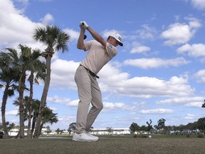 Mackenzie Hughes hits his drive on the ninth hole during the final round of the 2020 Honda Classic golf tournament at PGA National (Champion).