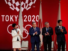 Tokyo Governor Yuriko Koike, Tokyo 2020 President Yoshiro Mori, International Olympic Committee (IOC) President Thomas Bach and Japan's Prime Minister Shinzo Abe attend the 'One Year to Go' ceremony celebrating one year out from the start of the summer games at Tokyo International Forum in Tokyo, Japan July 24, 2019.