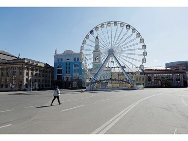 Yulia Kochetova-Nabozhniak, co-founder of the Veterano Brownie cafe walks along the empty street as she delivers brownie cakes in central Kiev Ukraine March 23, 2020.