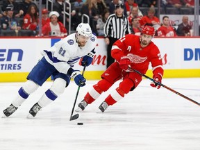 Tampa Bay Lightning defenseman Erik Cernak skates with the puck past Detroit Red Wings center Dylan Larkin in the second period at Little Caesars Arena.
