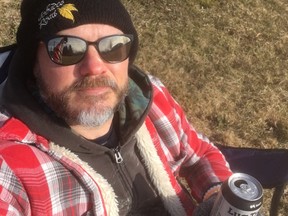 Sun sports columnist Jon McCarthy in self-quarantine, outside with beer in hand.