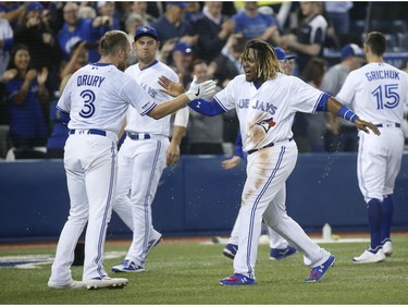 Toronto Blue Jays Brandon Drury 3B (3) is congratulated by Toronto Blue Jays Vlad Guerrero Jr. 3B (27) after hitting a two-run homer In the ninth inning in Toronto, Ont. on Friday April 26, 2019.