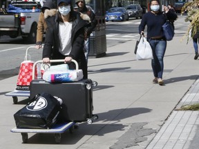 A few stay active on the streets of downtown Toronto on Friday, March 20, 2020. (Veronica Henri/Toronto Sun/Postmedia Network)
