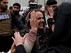 An Afghan Sikh woman reacts near the site of a Sikh religious complex attack in Kabul, Afghanistan, Wednesday, March 25, 2020.